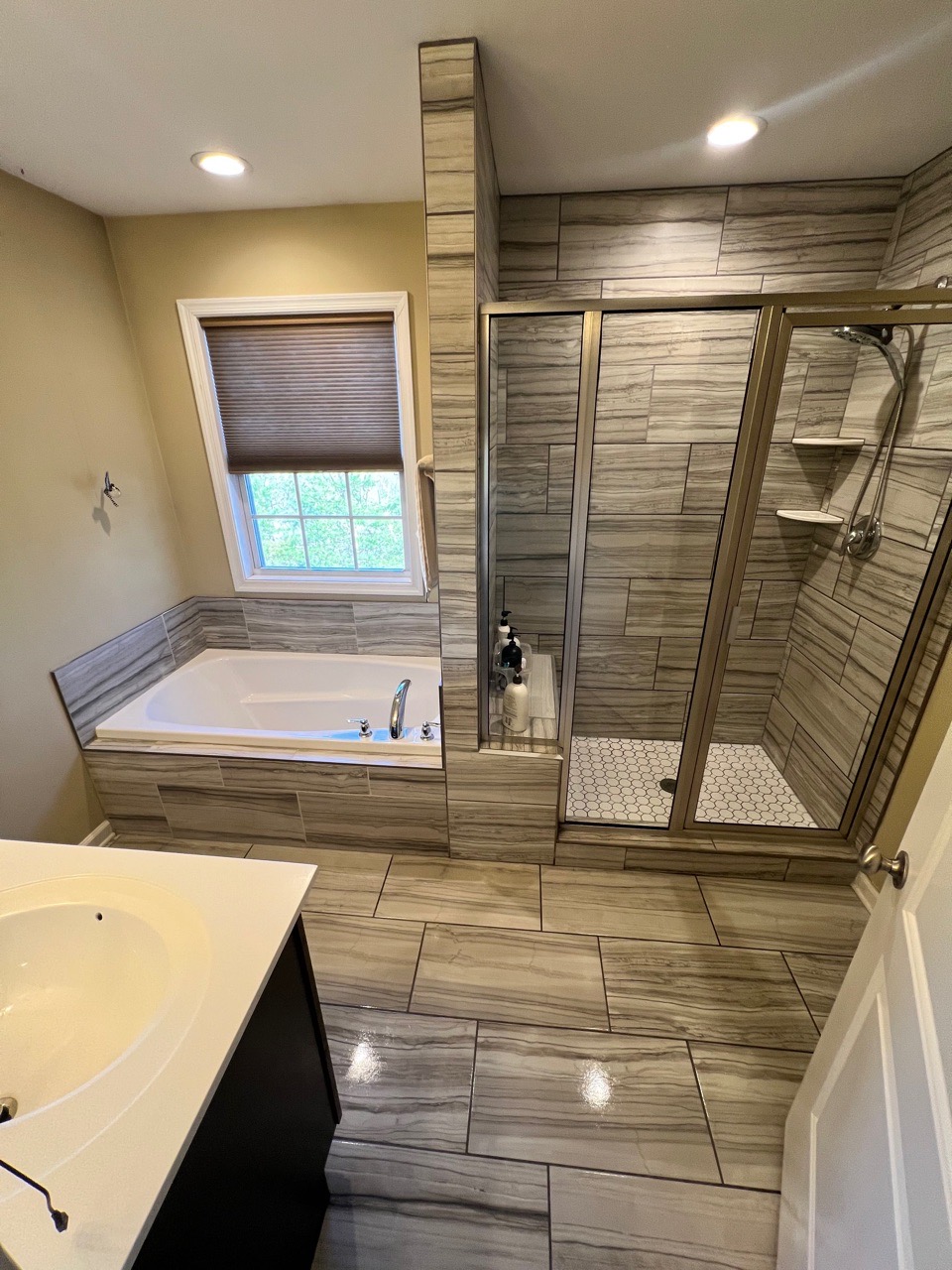 modern bathroom with clean tiles bathtub and glass shower after deep cleaning