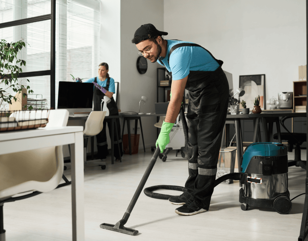 professional cleaner vacuuming office floor in commercial workspace