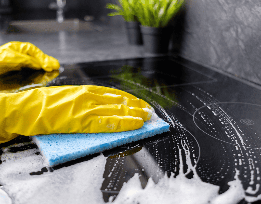 cleaner wiping and sanitizing kitchen surfaces thoroughly